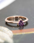 deep purple pink trillion shape rose gold bena jewelry bridal ring on a dark background