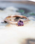 purple garnet rose gold minimalist bridal ring on a multi color background