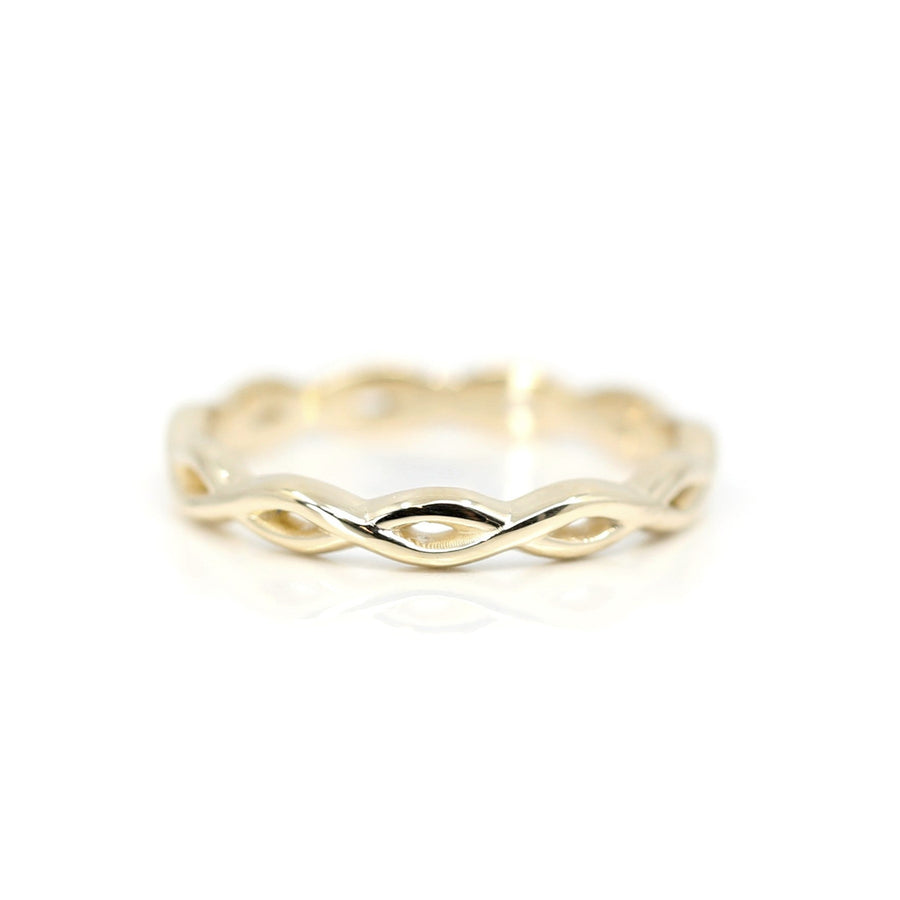 front view twist style yellow gold custom made wedding band montreal by designer bena jewelry best canadian bridal ring on white background