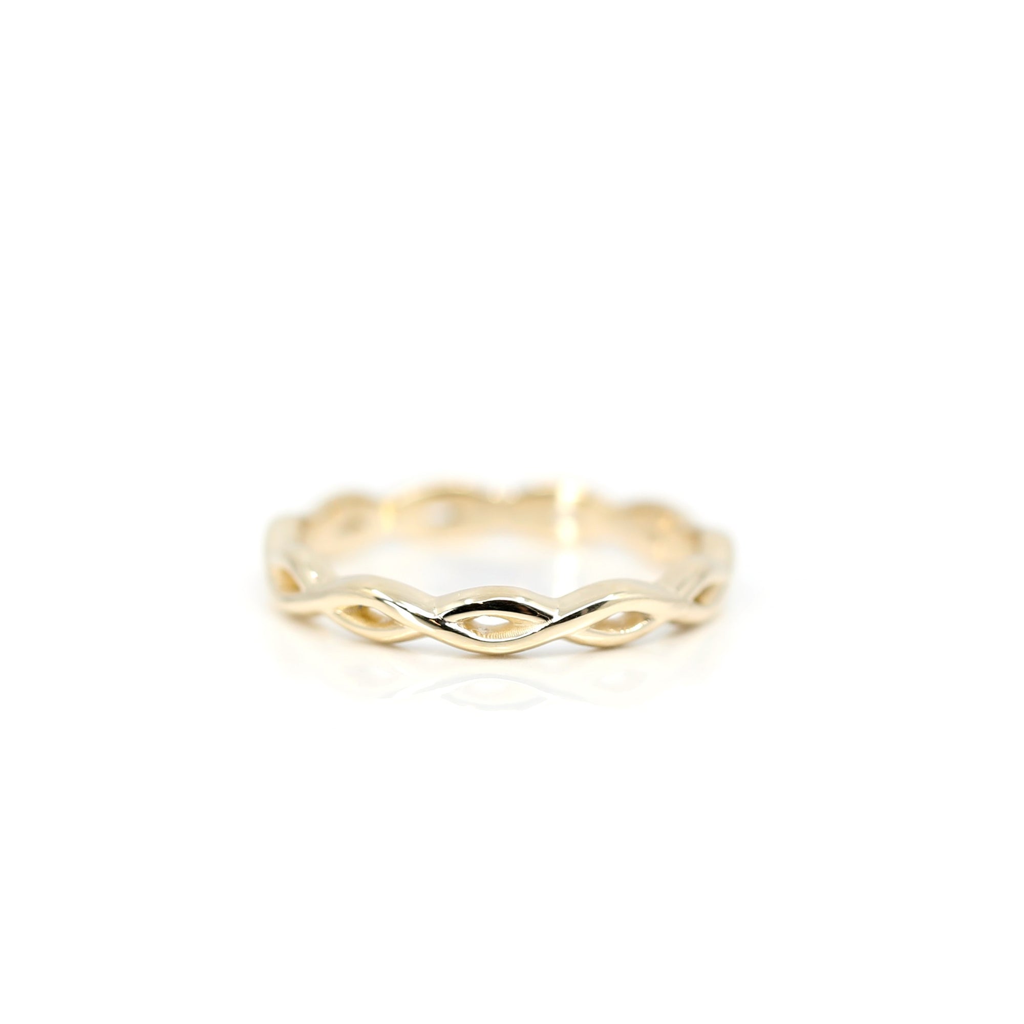 Braided Ring in Yellow Gold on white background – A delicate wedding band with an infinity-inspired braided design, handcrafted by Bena Jewelry in Montreal.