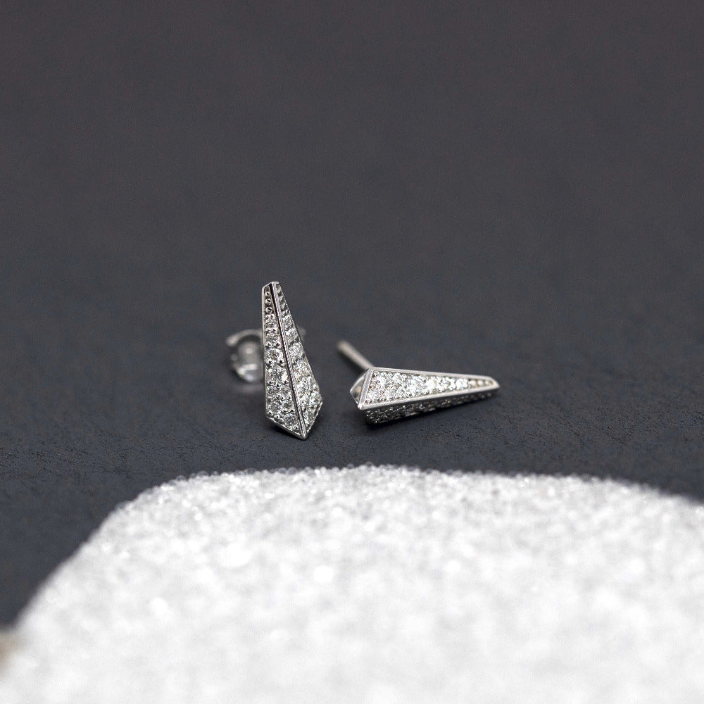 Contemporary diamond earrings with a minimalist design, part of the Fancy Edgy collection, shown against a gray backdrop by Bena Jewelry.