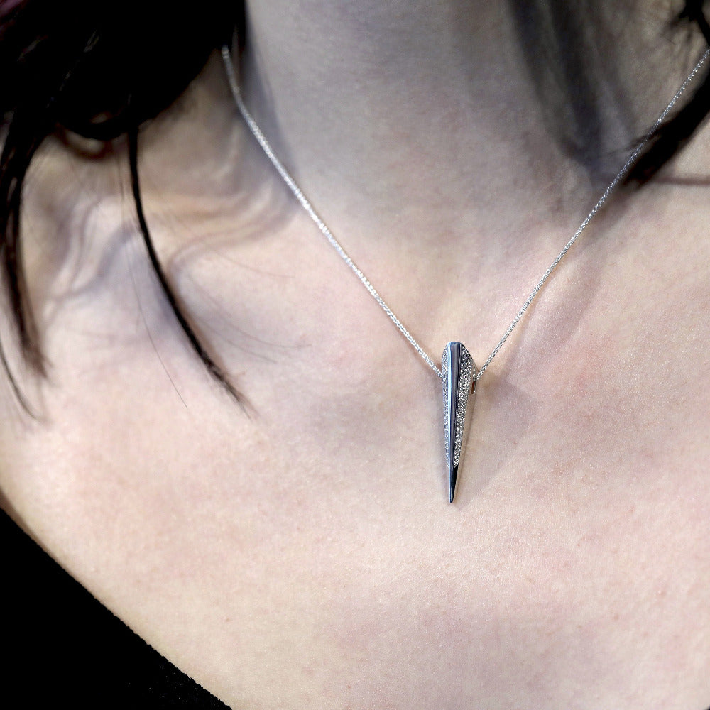 Close-up of Diamond Pike Pendant worn, highlighting sparkling diamond lines and sleek white gold craftsmanship, made by Bena Jewelry.
