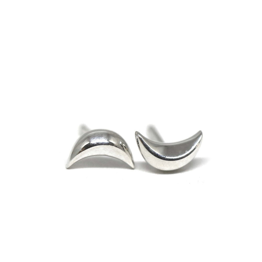 Crescent moon stud earrings in white gold by Bena Jewelry, minimalist unisex design, displayed on a white background. Handmade in Canada.