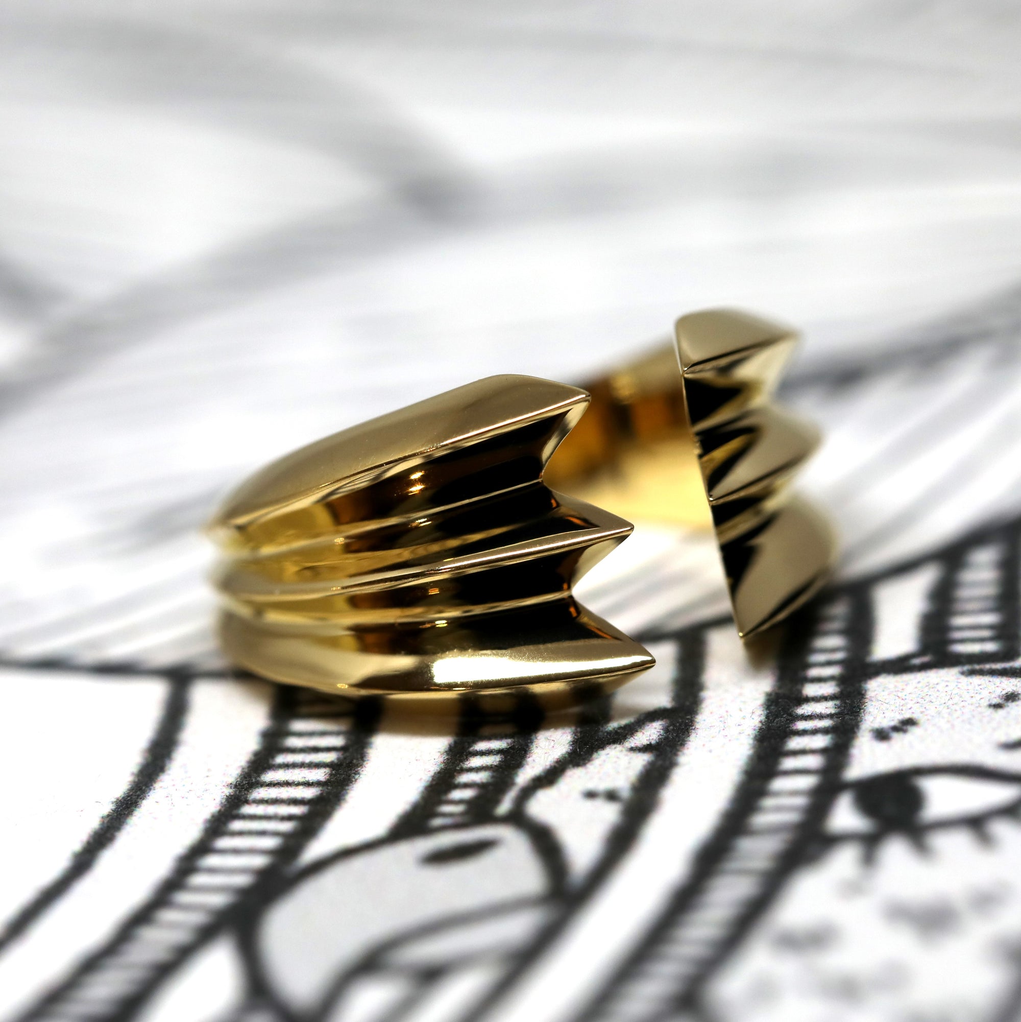 Angled shot of Crush Ring in Yellow Gold – A sculptural unisex ring with a refined yet daring presence, designed by Bena Jewelry.