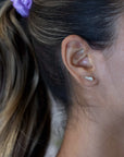 girl wearing yellow gold diamond blade stud earrings by bena jewelry designer montreal