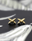 gold stud earrings edgy cross shape by bena jewelry designer montreal