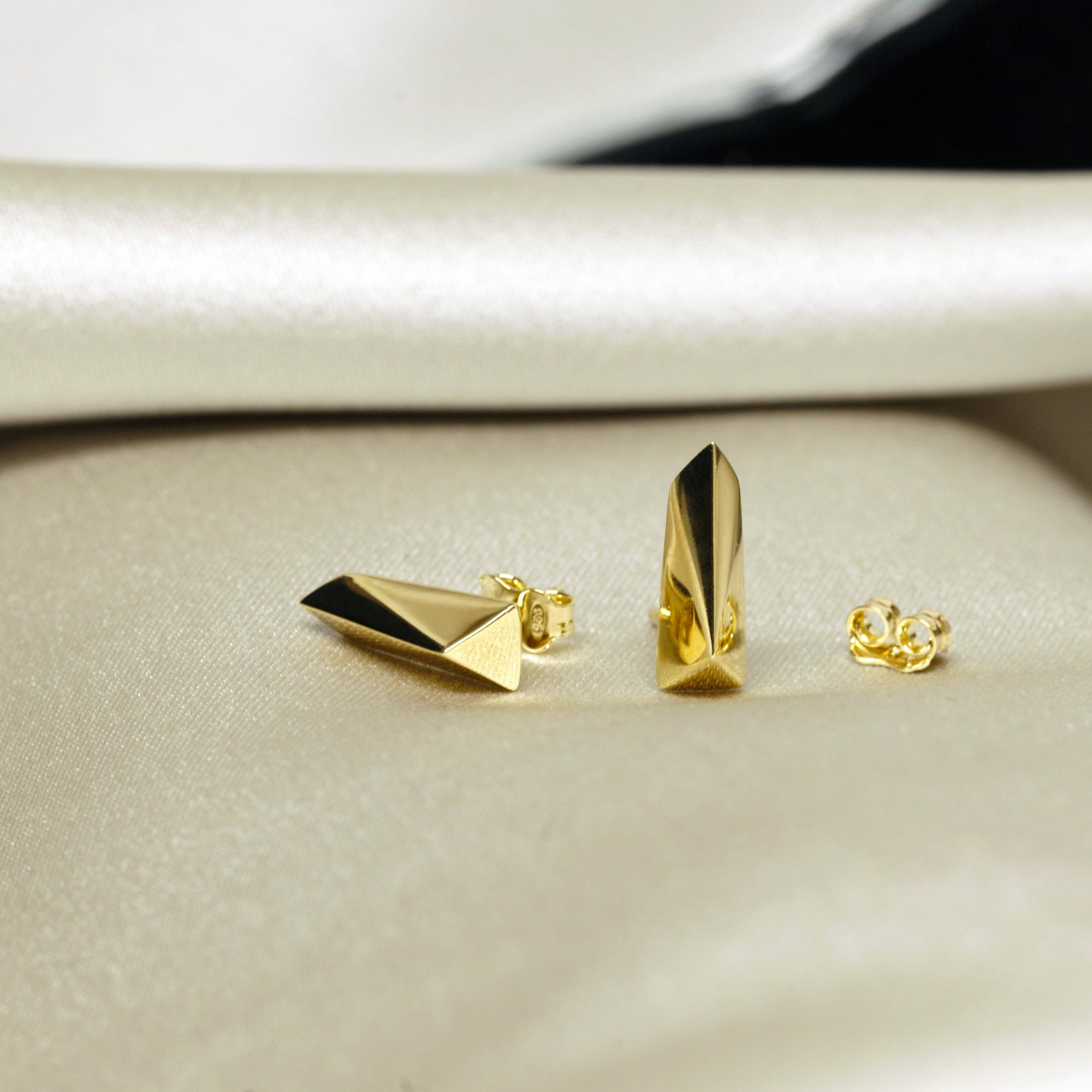 Angled shot of Pike Earrings on white background – Unisex gold earrings with a sleek, minimalist design. A refined statement piece crafted by Bena Jewelry in Montreal.