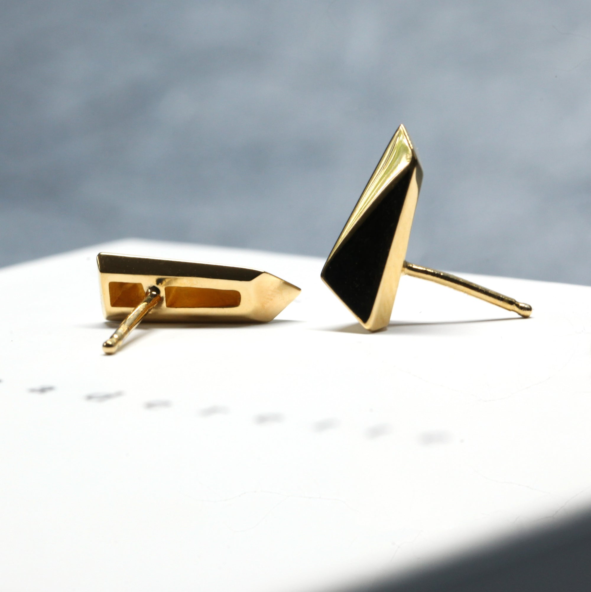 Close-up of Pike Earrings worn on ear – Modern geometric earrings in solid gold, designed for an edgy and elegant look. Handmade in Canada by an independent jewelry designer.
