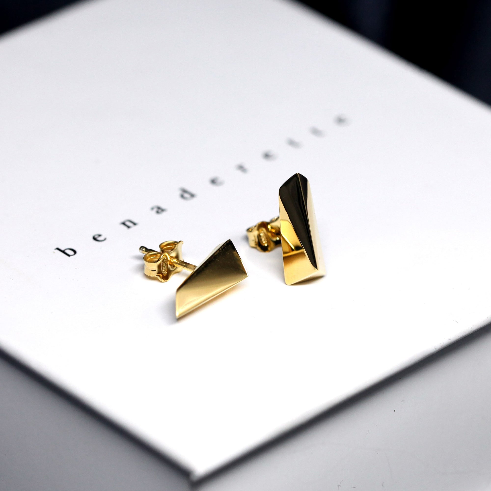 Close-up of Pike Earrings – Bold and contemporary gold earrings with sharp, sculptural lines. Designed by an independent Canadian jewelry artist.
