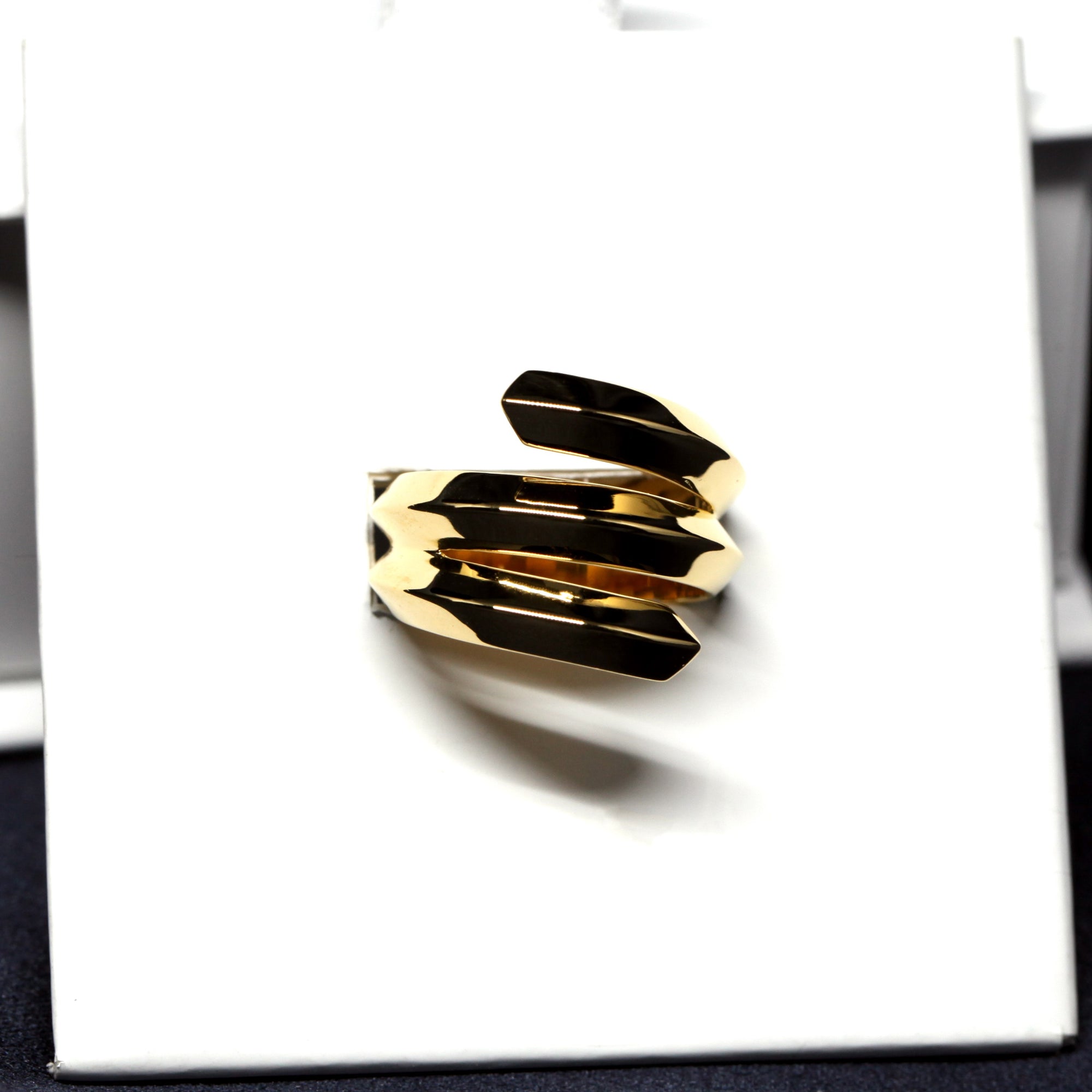 Close-up of Embrace Ring in Yellow Gold – A statement designer ring with a strong geometric structure and high-polish finish.